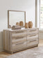 Hasbrick Queen Panel Bed with Mirrored Dresser, Chest and Nightstand